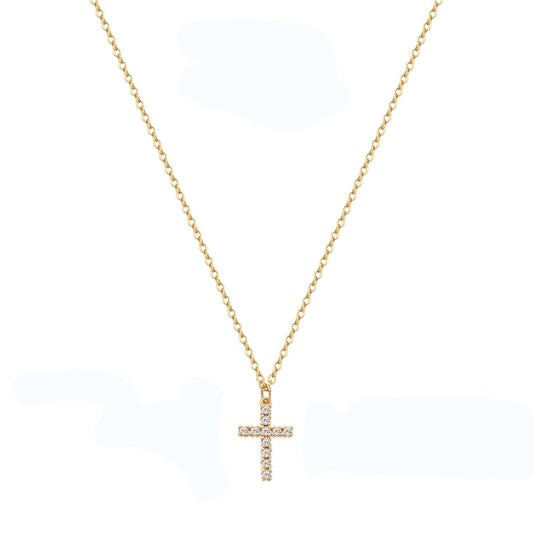 A gold waterproof stainless steel cross necklace with small embedded stones, on a fine chain.