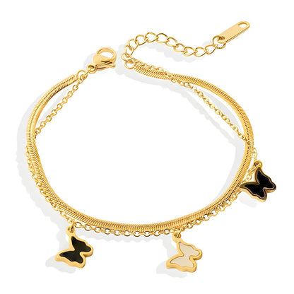 A gold-pvd stainless steel bracelet with multiple chains and butterfly charms.
