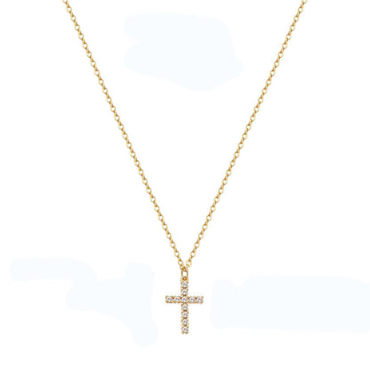 A gold waterproof stainless steel cross necklace with small embedded stones, on a fine chain.