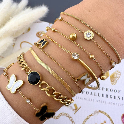 Minimal gold stacking bracelets on model 